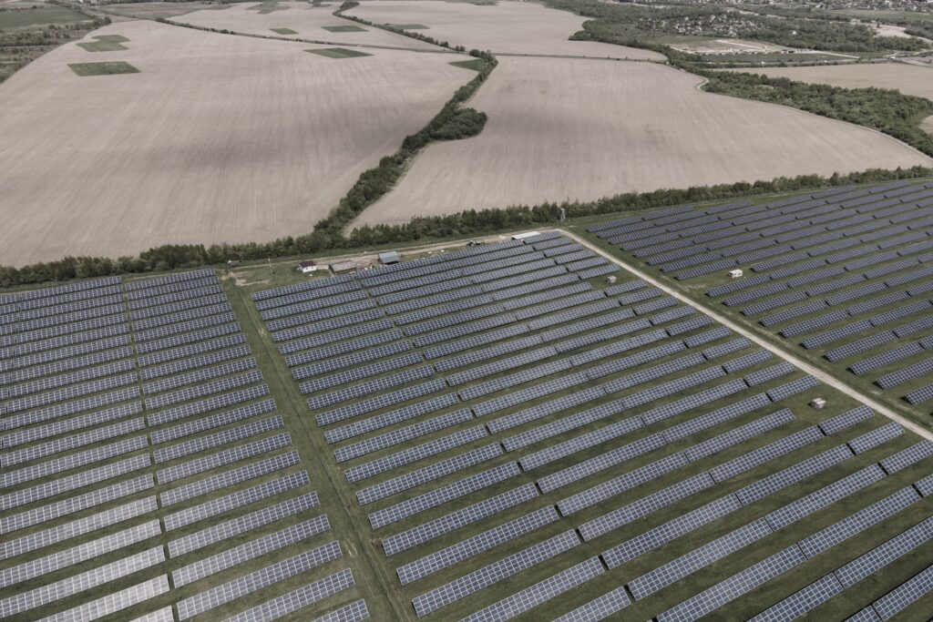 Large solar array next to harvested farm fields